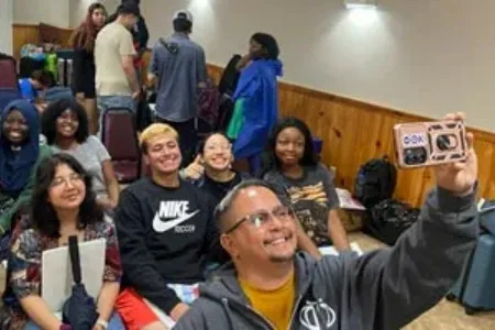 Group of students taking a selfie in a classroom.