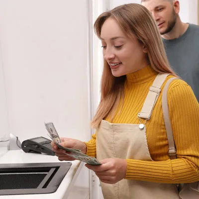 Female student paying for their classes in person