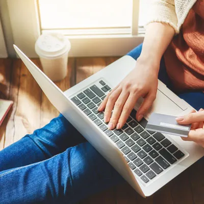 Student paying online from their laptop at home