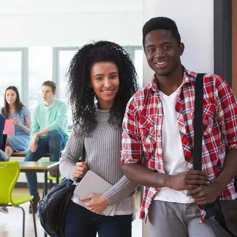 Two students standing in a classroom setting