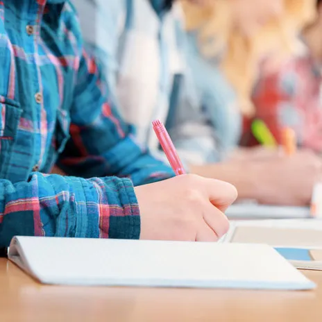 Students writing in notebooks during classroom study session