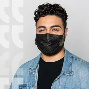 Student in jean jacket wearing a black medical face mask