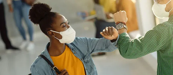 a person wearing a mask is being given a shot