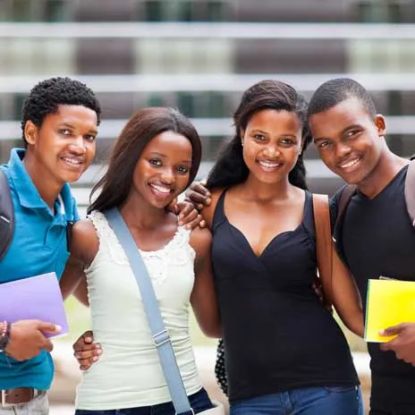 Diverse group of students is smiling and holding notebooks, symbolizing inclusivity and support