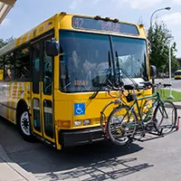 A DART bus parked at a DART station with a bike mounted on the front of the bus