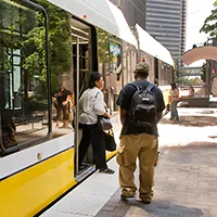 Passengers load a DART rail train