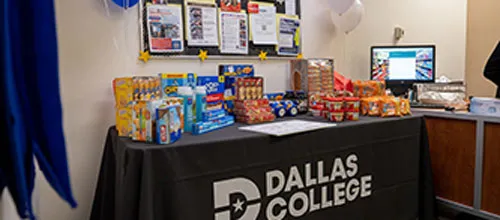 Dallas College snack table with cereal, granola bars, and balloons.