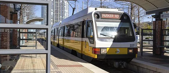 A DART rail train waits at a train station