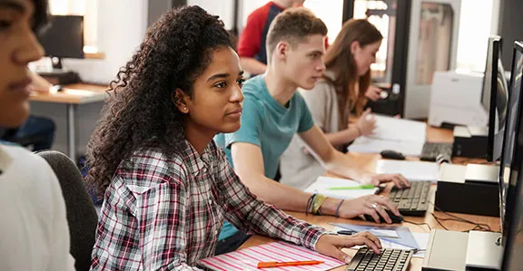Students working on desktop computers in a computer lab.