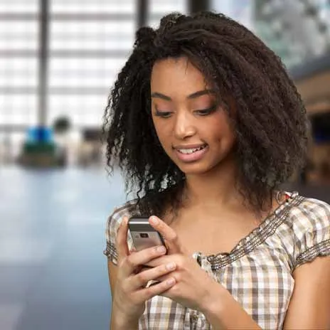 Student checking a smartphone in a public indoor space