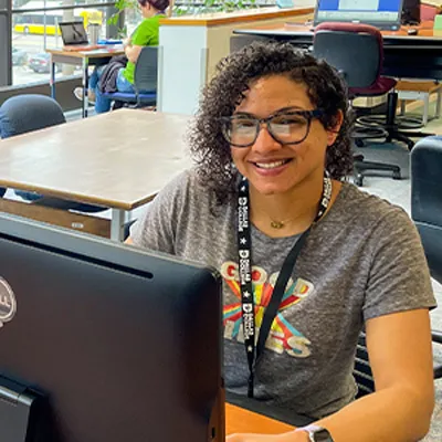 Student sit behind computer monitors in the computer lab