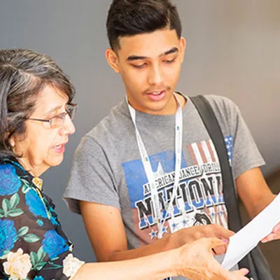 A student and an instructor review a piece of paper together