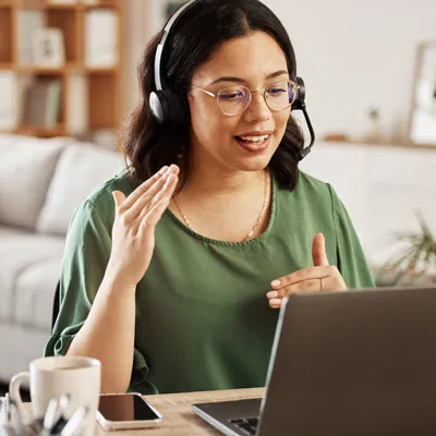 A student wearing a headset receiving tech support through a call