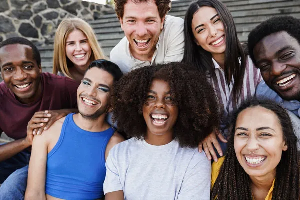 Group of happy young students on sitting on stairs