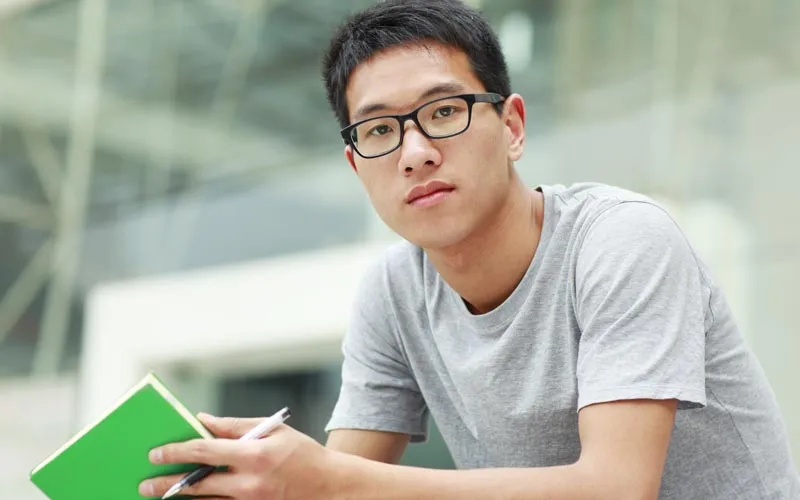 Asian college student sitting on steps