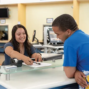Student receiving assistance at a service desk