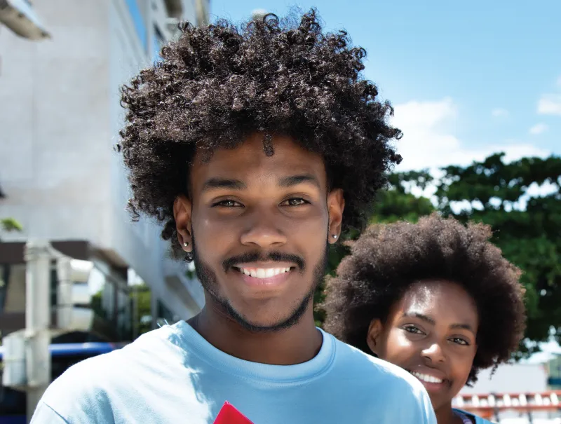 two students smiling outside of a Dallas College campus