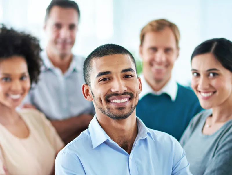 a group of students standing in a team formation smiling