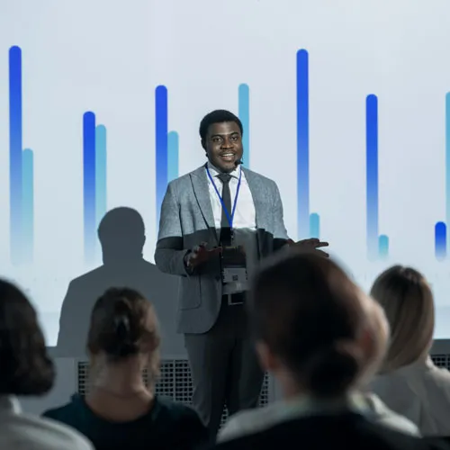 Successful Black Businessman Giving Presentation At International Business Conference.