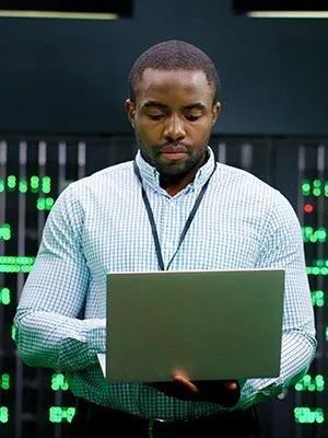 An IT worker in front of a laptop
