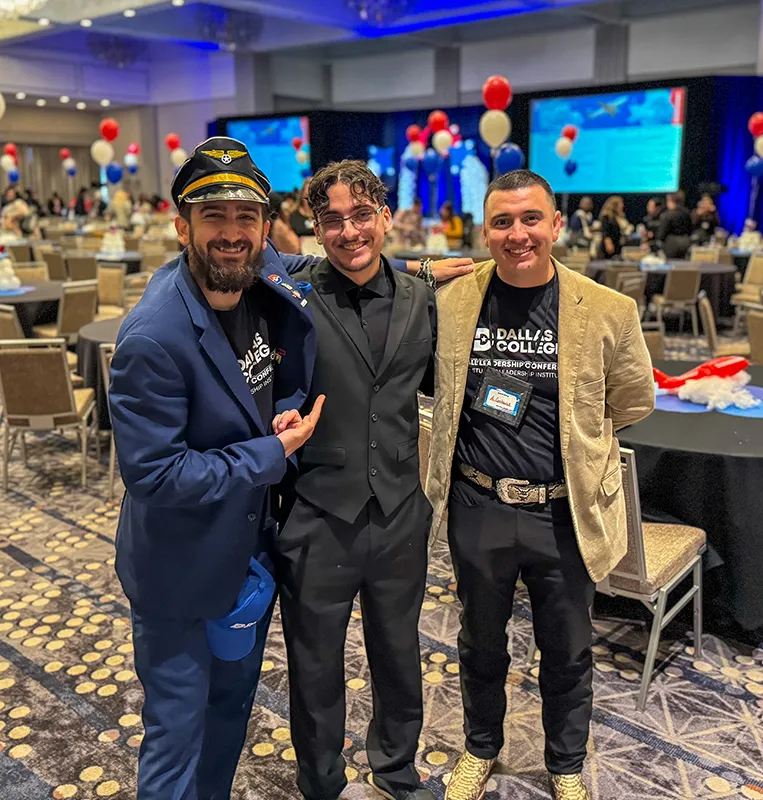 three male friends standing and smiling together