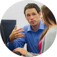Teacher talking to a student on a computer