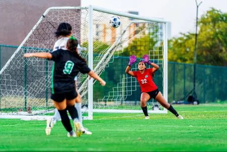 North Lake Women's Soccer Goalkeeper Sofia Falcon blocks a shot attempt.