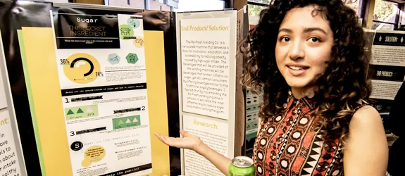 An RCHS student shows off their science fair project