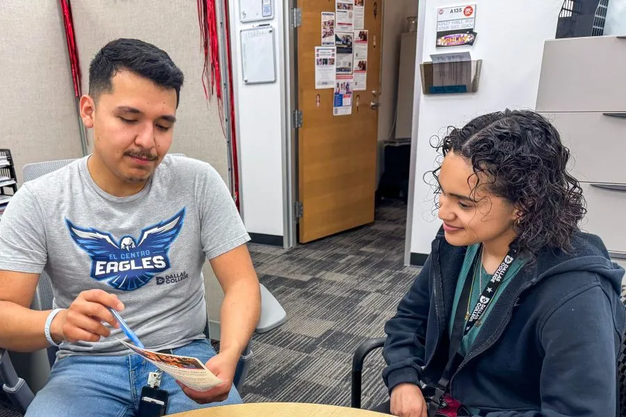 A student talks about their options with a Success Coach in their office