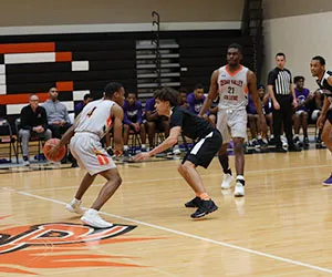 The Cedar Valley Suns dribble the basketball up the court in front of an opposing player