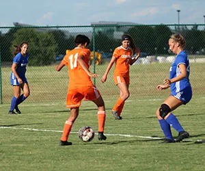 Cedar Valley Women's Soccer player dribble the ball down the field