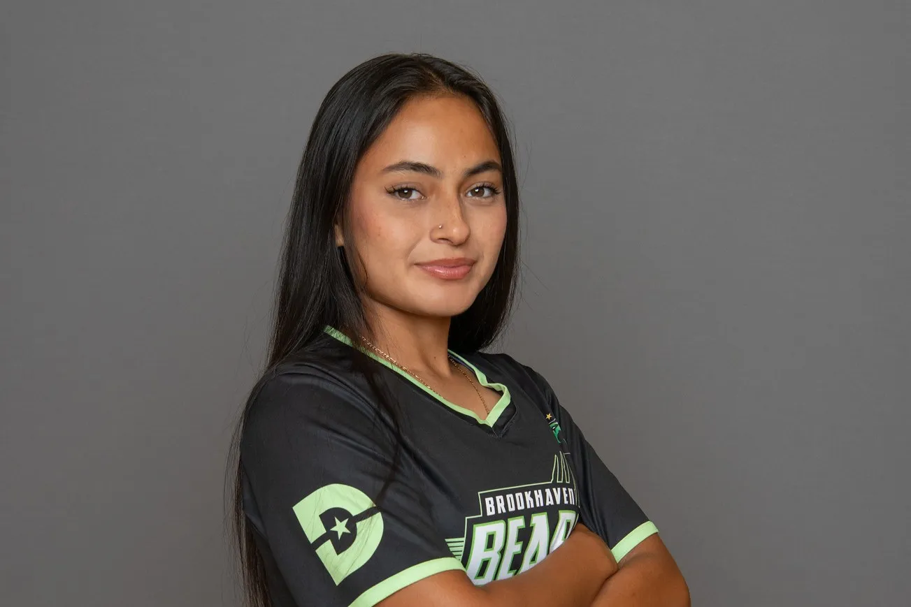 A Brookhaven women's soccer player stands with arms crossed.
