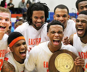 Eastfield basketball players cheer as they hold their championship trophy