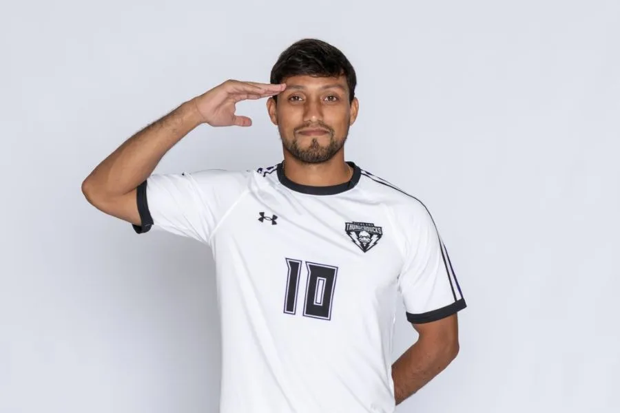 A Richland Soccer player stands and salutes