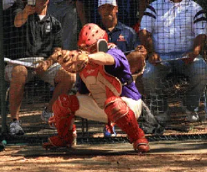 A Richland catcher grabs the ball after the pitch