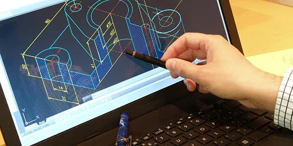Someone uses a stylus to manipulate a CADD drawing on a laptop screen.