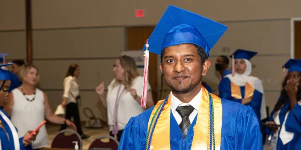 Student at Graduation wearing graduation robe and hat
