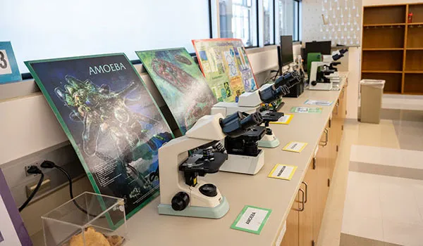 Microscopes line the shelf in the science lab at Richland