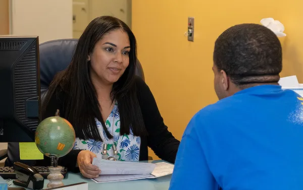 A photo of a student being helped by a business office employee