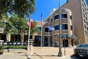 El Centro Campus entrance with flagpoles and campus buildings in a downtown setting.