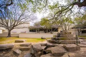 Mountain View Campus outdoor courtyard with rock landscaping, trees and campus buildings.
