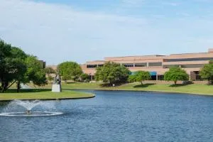 North Lake Campus lake with a fountain, landscaped grounds, and campus buildings.