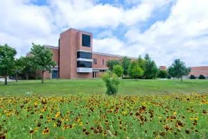 Richland Campus lawn with wildflowers and campus buildings.
