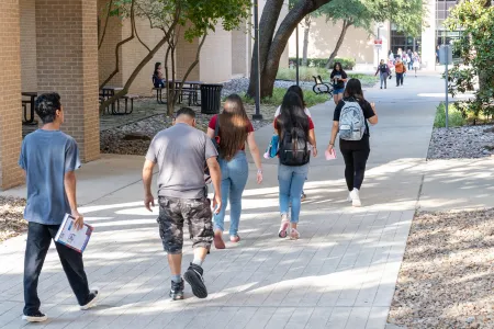 students walking to college building
