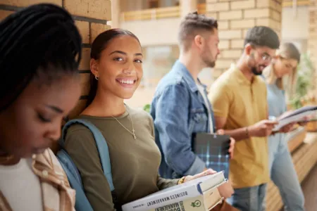 students in hallway holding books