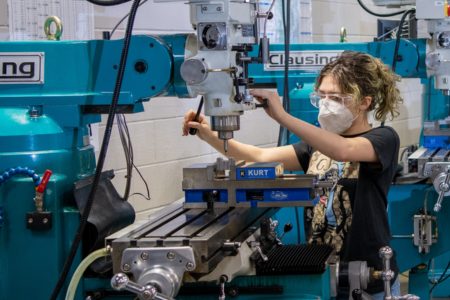 Person operating a machine in a workshop.