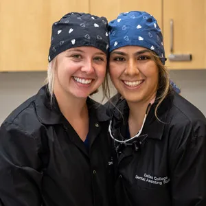 Two dental students in black uniforms.