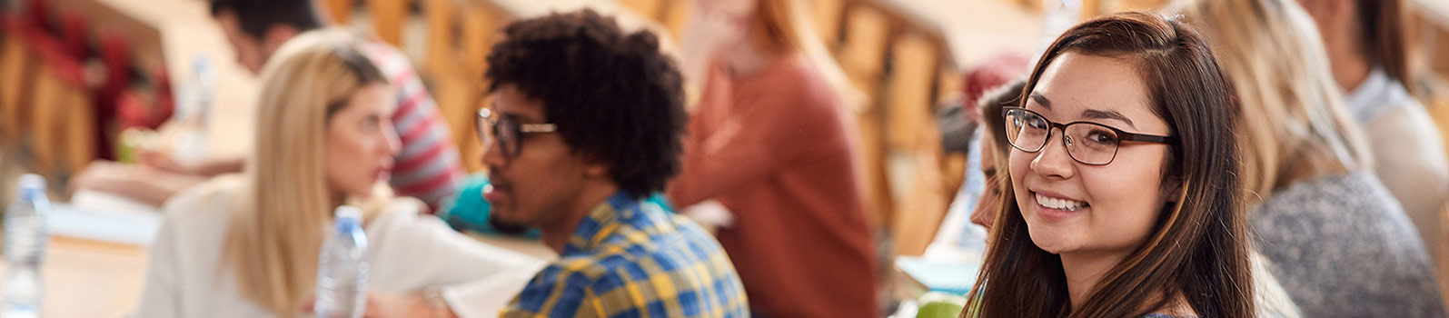 Student smiling surrounded by other students