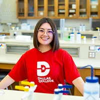 female student in a science lab with a red shirt