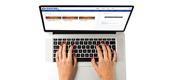 Overhead view of a student viewing a Dallas College web page on their laptop